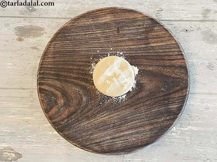 Step 22 – Flatten the dough ball with your hands.