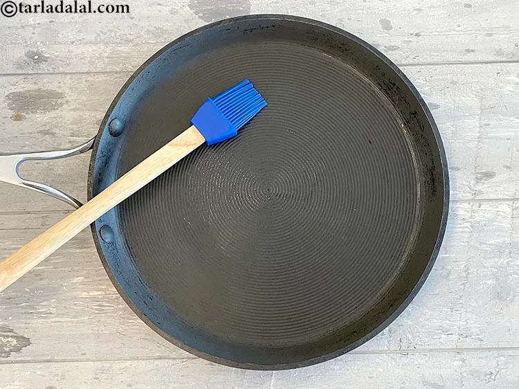 Step 26 – Grease a non stick pan with 1/4 teaspoon oil.