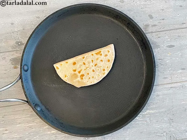 Step 29 – Flip the paratha over and cook the other side&nbsp;till golden brown spots appear.