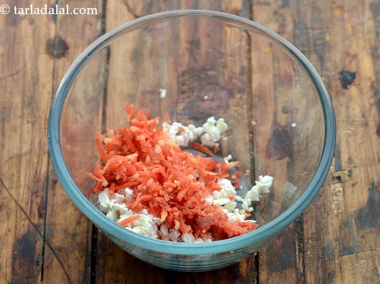 Step 9 – To this add veggies. Begin with grated carrot.