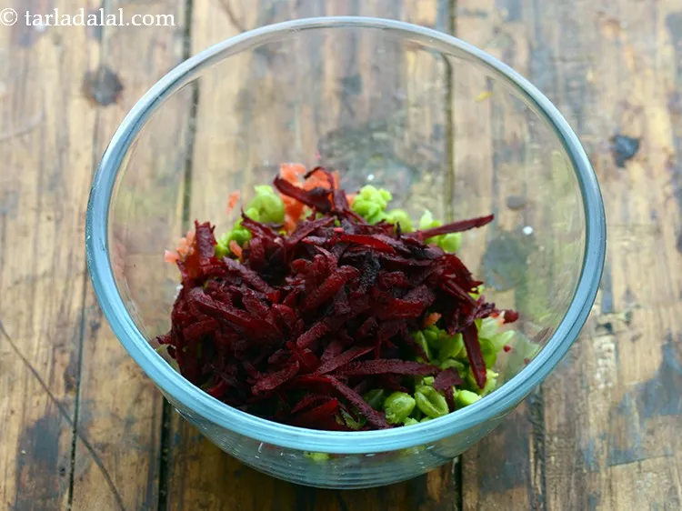 Step 11 – Add some grated beetroot as well. This lends a pretty pink colour to the stuffing …