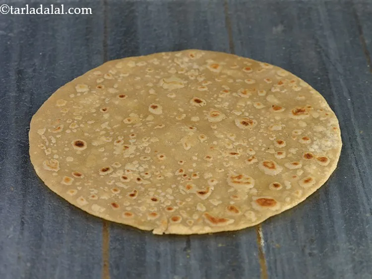 Step 27 – Place the cooked chapatti on a flat surface or a plate.&nbsp;