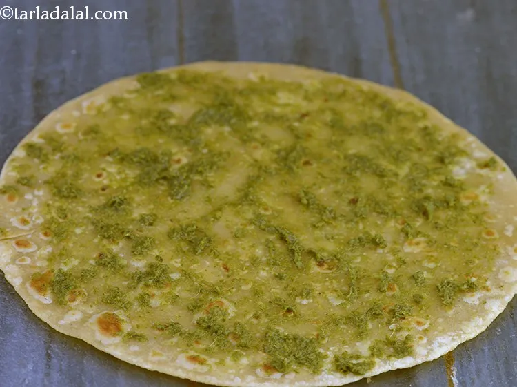 Step 28 – Once placed on dry surface, apply 1 tsp of chutney over the roti.