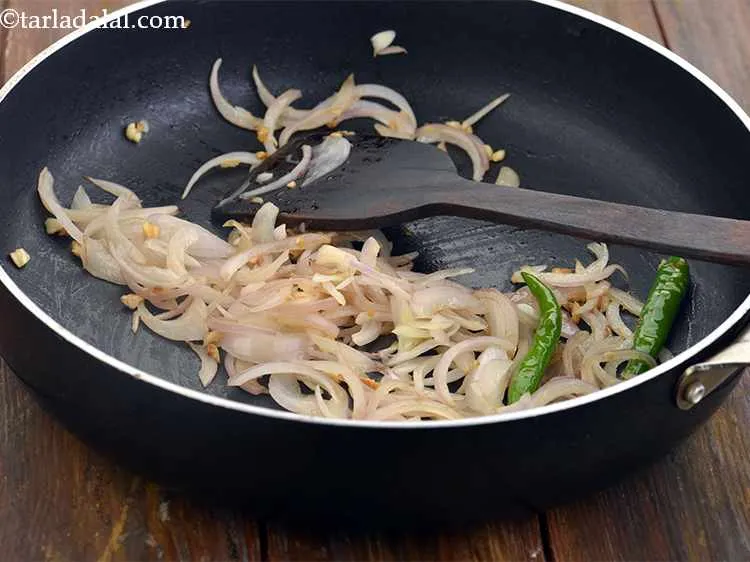 Step 41 – Add the slit green chillies, sliced onions and little salt and saut? on a medium …