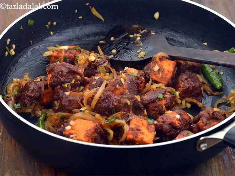 Step 43 – Add the fried paneer and spring onions, mix gently and cook on a medium flame …