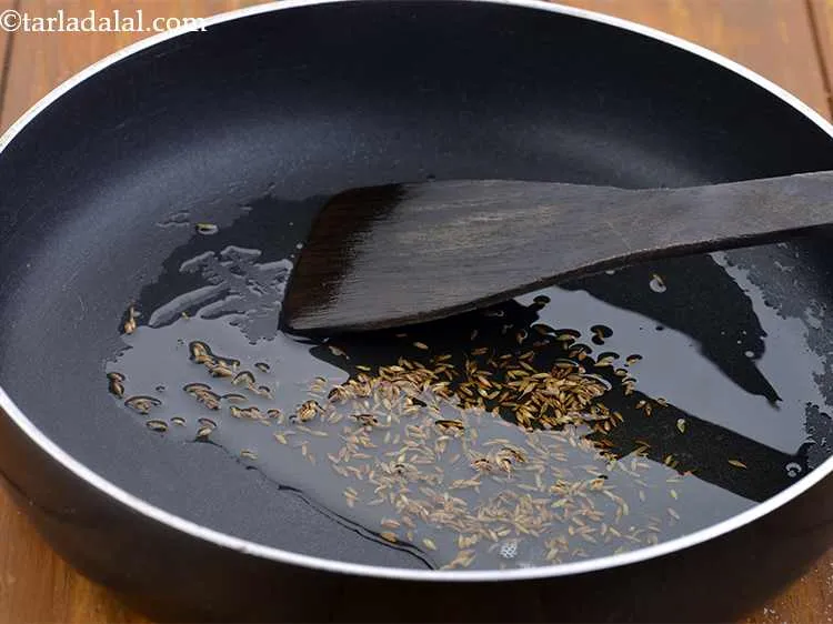 Step 1 – Heat the oil in a broad non-stick pan and add the cumin seeds.
