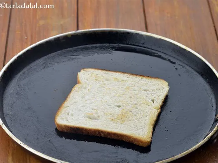 Step 11 – Place a bread slice on it and cook till it turns light brown in colour …