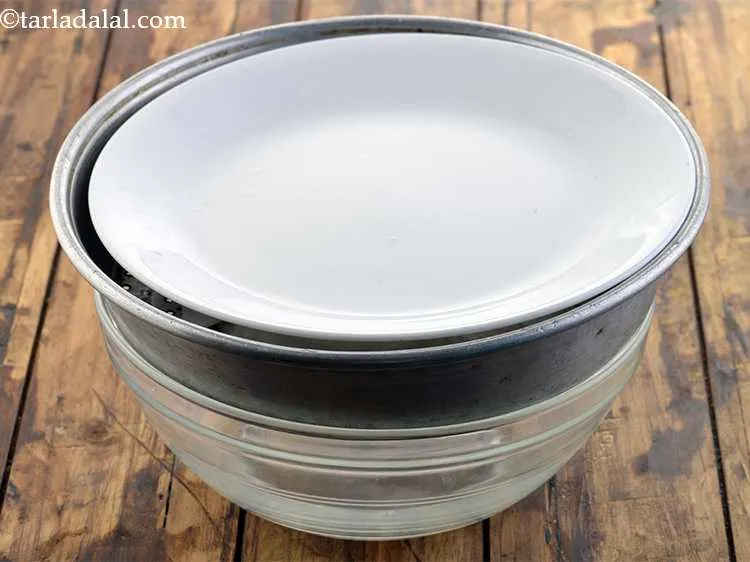 Step 27 – Put a plate over it. The plate is kept so that the weight is evenly …