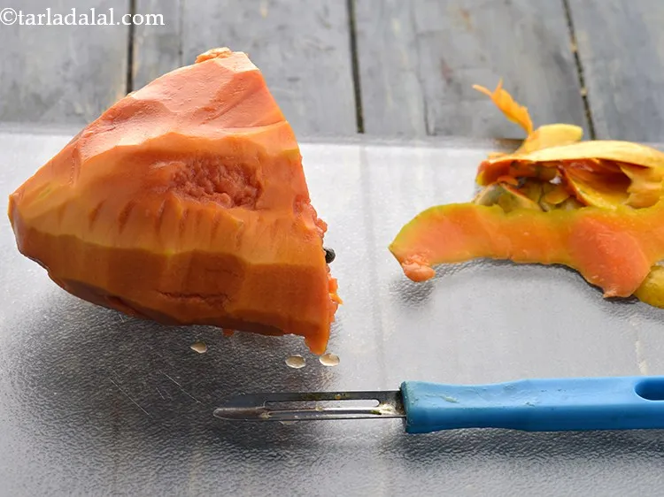 Step 7 – Peel the papaya using a sharp knife and discard the peel.&nbsp;