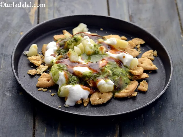 Step 18 – Also, drizzle 1&frac12; tbsp <a href="https://www.tarladalal.com/Green-Chutney-(Chaat)-2797r" target="_blank">green chutney</a>. The quantity of all the chutneys have …