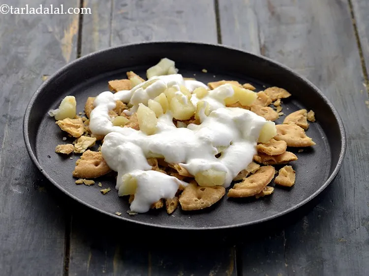 Step 16 – Drizzle around &frac14; cup curds. <strong>Papdi chaat</strong> tastes better with chilled yogurt so, refrigerate it …