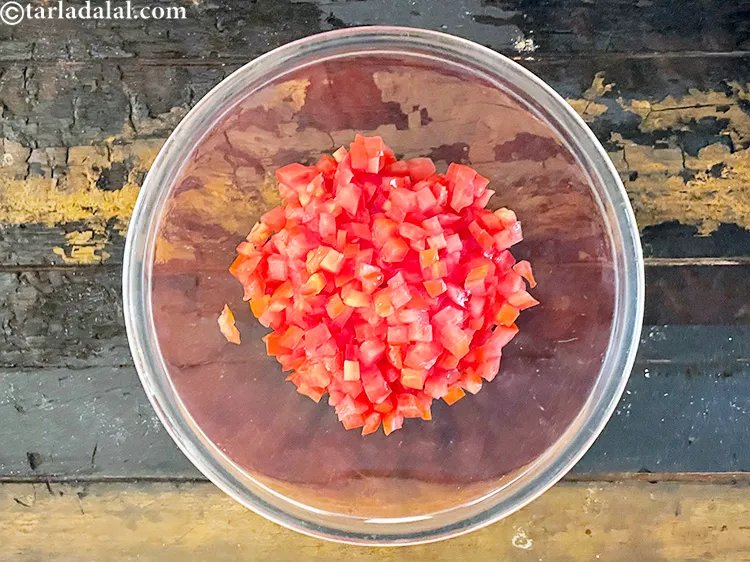 Step 15 – For the <strong>herbed tomato salsa</strong>, add 1/2 cup&nbsp;finely&nbsp;<a href="https://www.tarladalal.com/glossary-chopped-tomatoes-779i">chopped tomatoes</a> in a deep bowl.&nbsp;