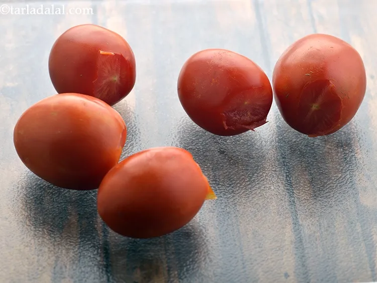 Step 13 – Scoop out and discard the eyes of the tomatoes using the tip of a sharp …