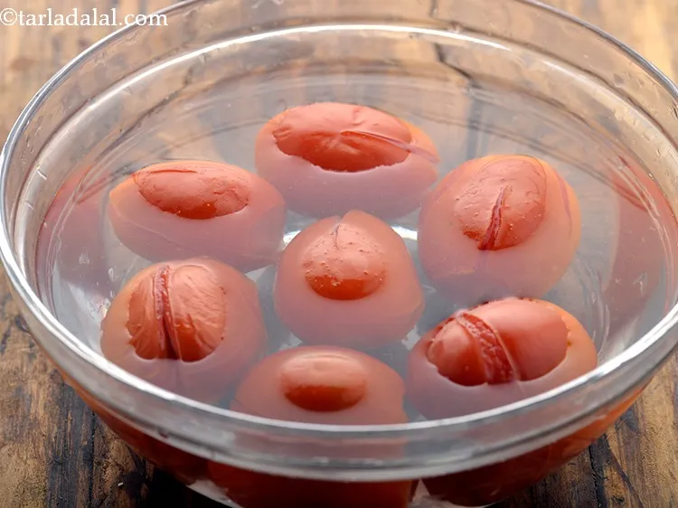 Step 16 – Using a slotted spoon remove the tomatoes from hot water. Immerse them in cold water …