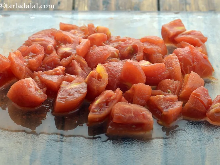 Step 17 – When the tomatoes are cooled, peel and discard the skin and seeds.&nbsp; Chop roughly on …