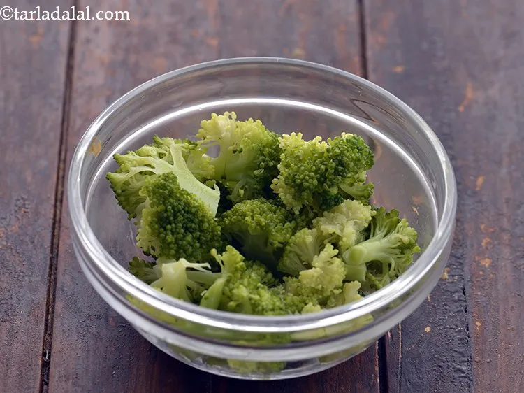 Step 15 – Clean a broccoli head and cut it into florets. In a microwave safe bowl, take …