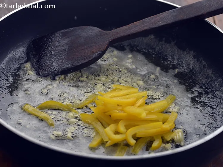 Step 22 – Add the yellow capsicum strip. Also, you can chop them in cubes or triangular pieces.