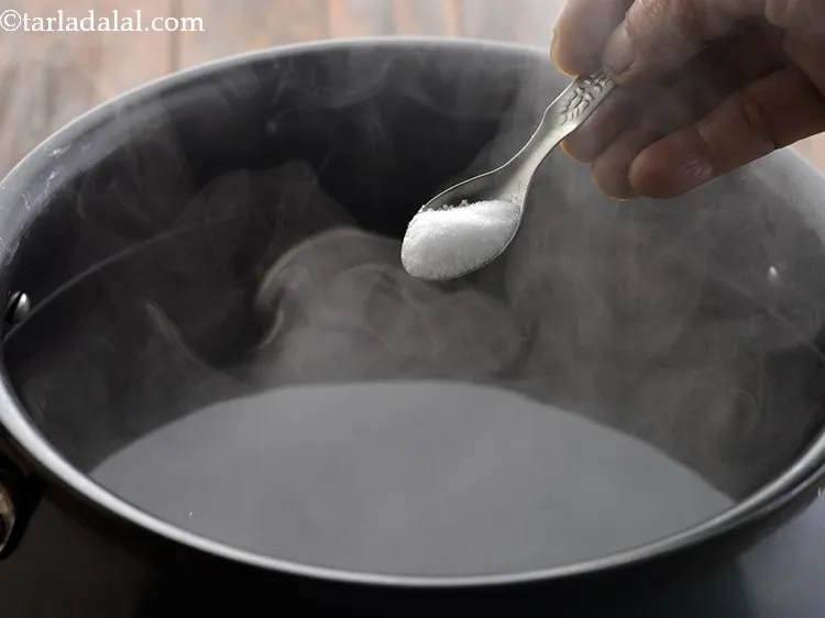 Step 7 – Once the water boils vigorously, add salt to taste. The salt will season the fusilli …