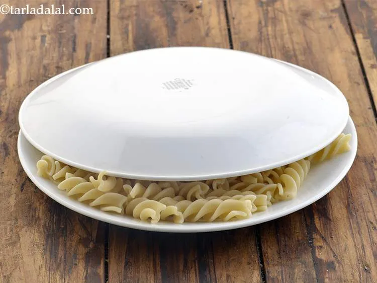Step 21 – Cover with a lid and keep aside. This will prevent the pasta from drying out.&nbsp;