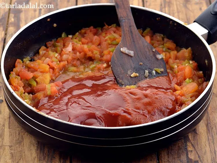 Step 34 – Now add the tomato pur&eacute;e and the tomato ketchup.