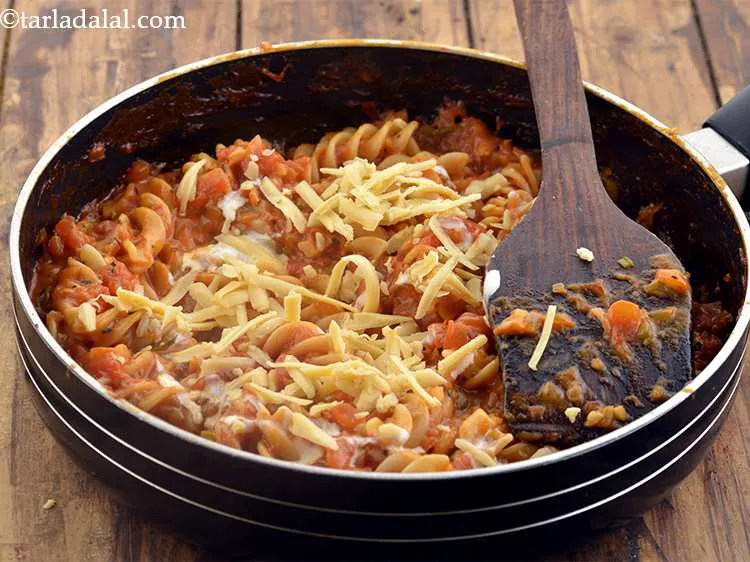 Step 43 – Also garnish the <strong>Pasta in red sauce</strong> with cheese.