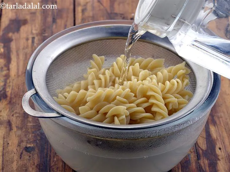 Step 17 – Refresh the pasta with cold water. This ensures that they stop cooking.