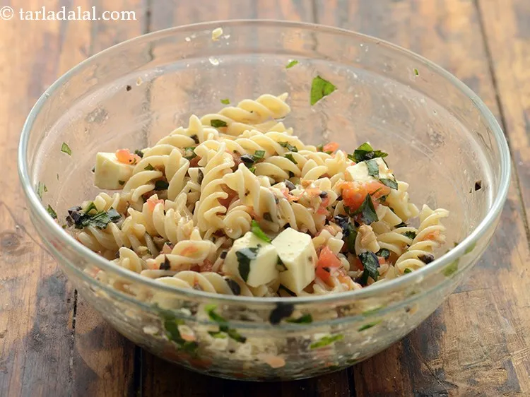 Step 14 – Mix&nbsp;<strong>pasta salad in vinaigrette | Indian style tomato pasta salad in basil vinaigrette dressing |</strong><strong>&nbsp;</strong>lightly.&nbsp;