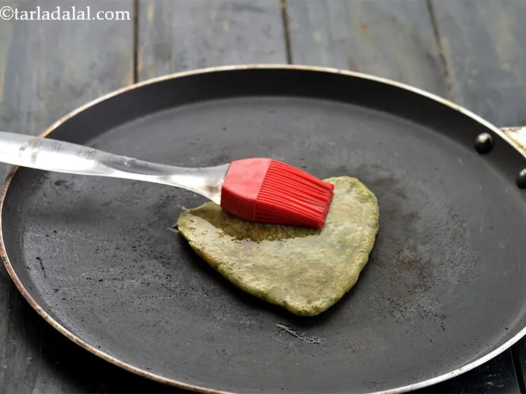 Step 23 – Flip and cook for a while and drizzle &frac14; tsp of oil.