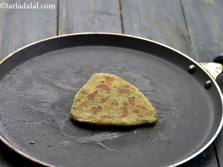 Step 24 – Cook till brown spots appear on both sides of the <strong>paratha</strong>.