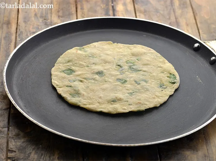 Step 16 – Heat a non-stick tava (griddle) and carefully place the <strong>Paushtic Roti </strong>over it. Cook the …