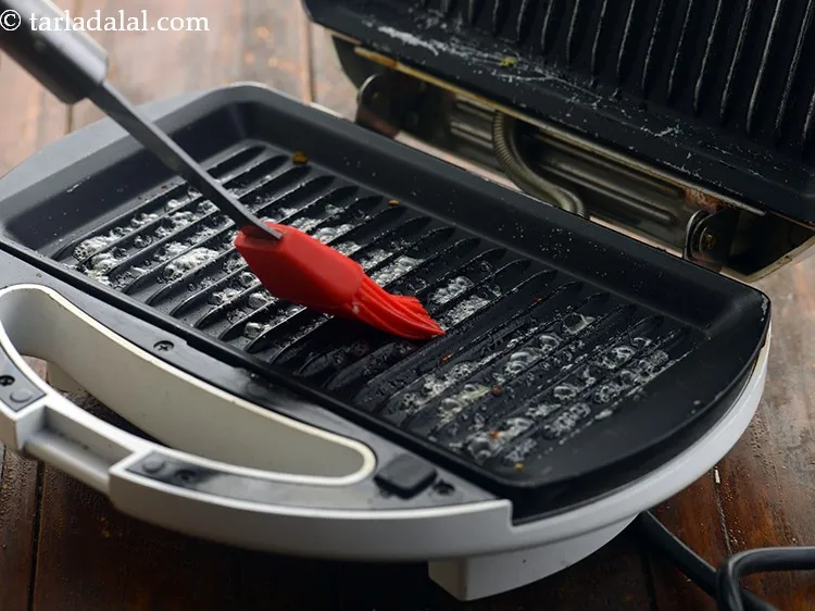 Step 32 – Grease the sandwich griller with 1 tsp of butter and allow it to heat up.