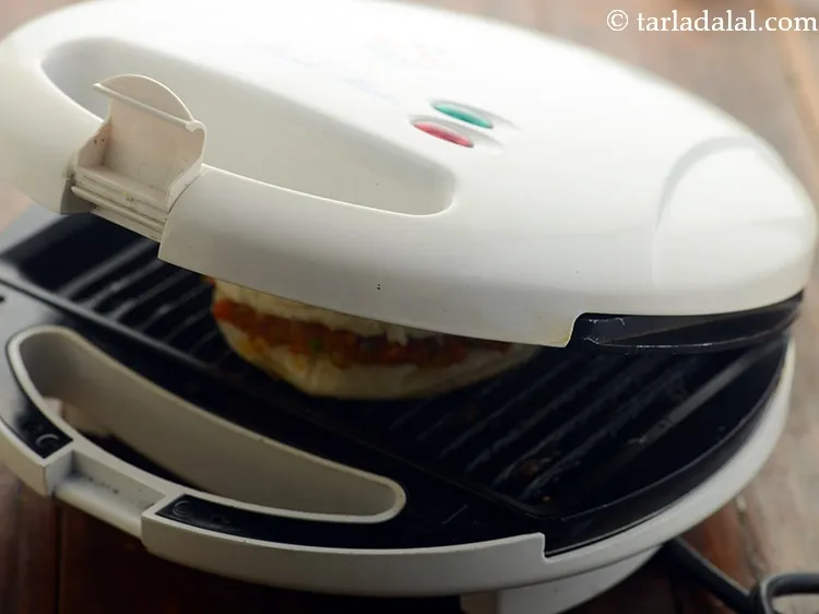 Step 33 – Place the <strong>bhaji pav burgers</strong> in the griller.