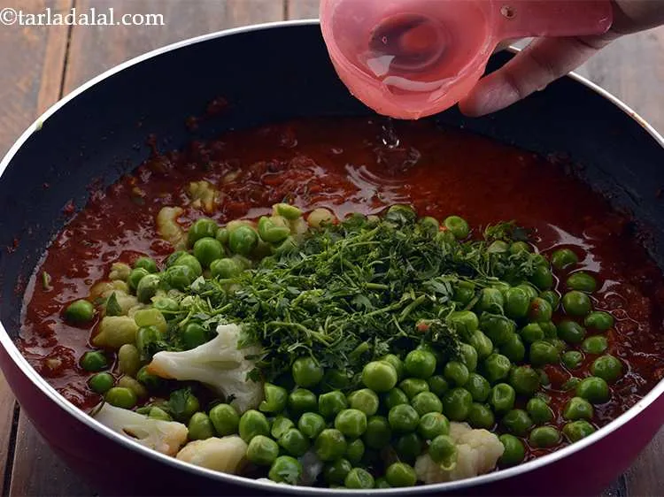 Step 20 – Add the coriander and 1/3 cup of water.