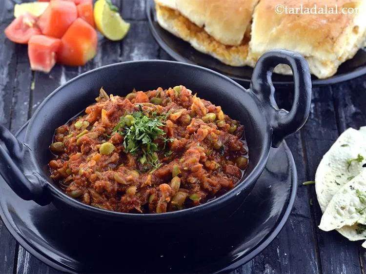 Step 30 – Place &frac14;th of the bhaji, 2 pavs, a few tomato slices, a lemon wedge and …