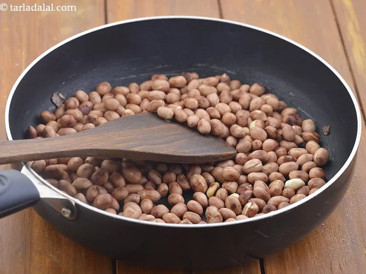Step 6 – Once the peanuts have been roasted, they will turn dark in colour with little black …