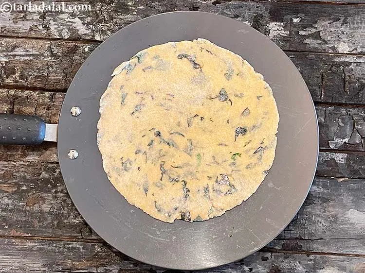 Step 14 – Heat a non-stick tava (griddle) and place the roti on it.