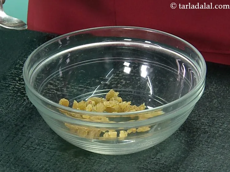Step 6 – In another deep bowl, add the raisins. Roughly chop them before adding.&nbsp;