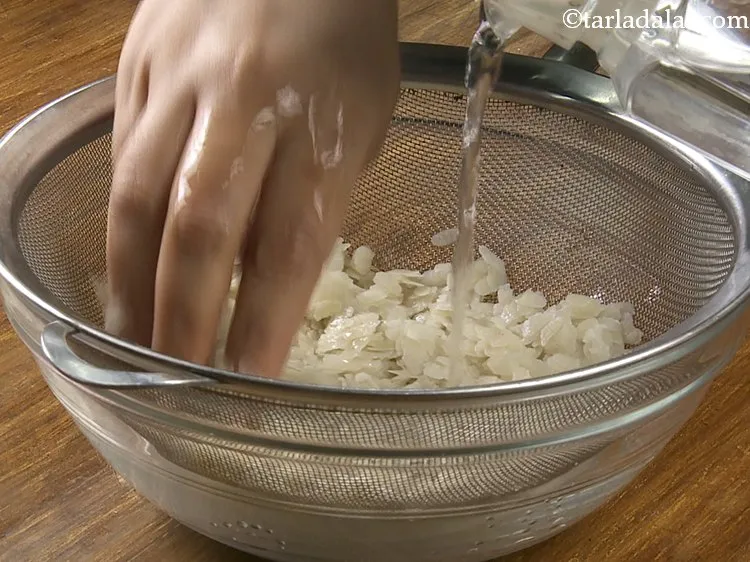 Step 37 – Hold poha under running water for a few seconds to soften them.