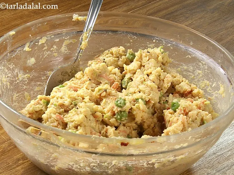 Step 28 – Mix well and our mixture for Poha Bhajia is finally ready! The addition of tempering …