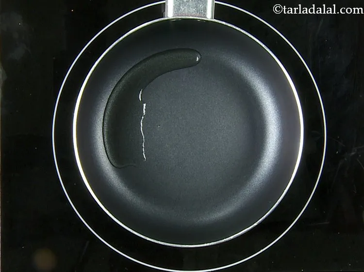 Step 23 – For the tempering the <strong>poha bhajia mixture</strong>, &nbsp;heat the oil in a small pan.