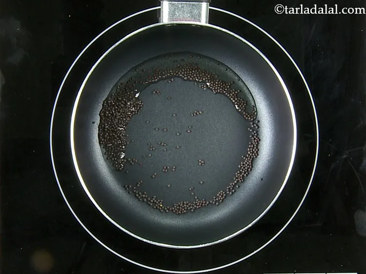 Step 24 – Once the oil is hot, add the mustard seeds.