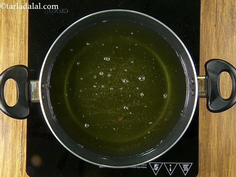 Step 29 – For frying the <strong>poha bhajia</strong>, heat the oil in a deep kadhai on a medium …