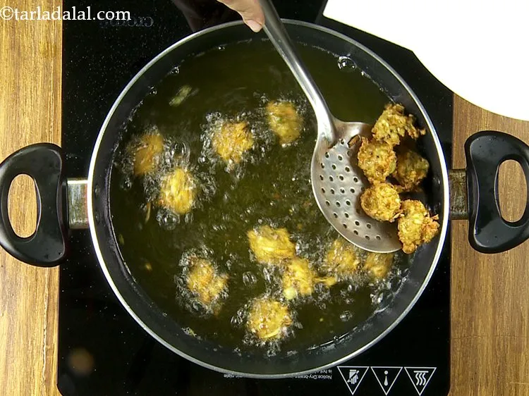 Step 32 – Keep flipping occasionally and frying till they turn golden brown in colour from all the …