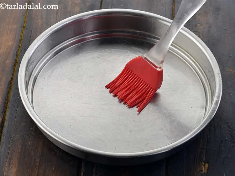 Step 16 – Grease a 175 mm. (7&rdquo;) diameter thali with a little oil. This will prevent the …