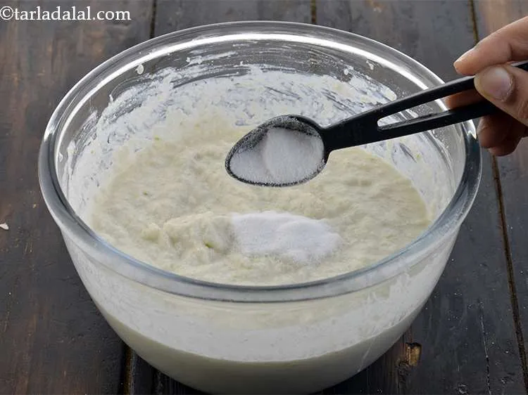 Step 13 – Just before steaming, add the fruit salt to the prepared <strong>poha dhokla</strong> batter. Fruit salt …