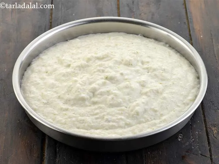 Step 17 – Pour the batter into this greased thali and shake the thali clockwise to spread the …