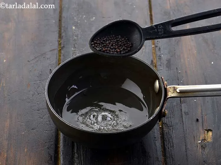 Step 22 – Add the mustard seeds (<em>rai</em>) to it and wait for it to crackle.