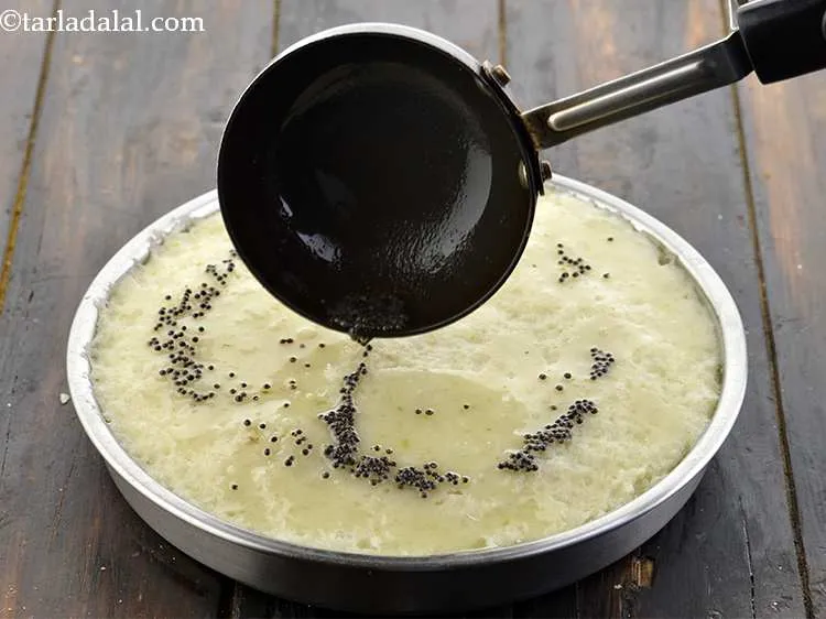 Step 24 – Pour the prepared tempering evenly the&nbsp;<strong>poha dhoklas | quick poha dhokla | instant poha dhokla …