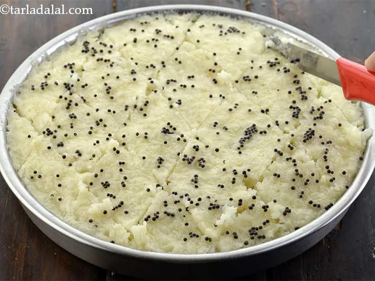 Step 26 – Cool slightly, cut&nbsp;<strong>Poha dhokla&nbsp;</strong>into diamond shaped equal sized pieces. It is important to cool them …