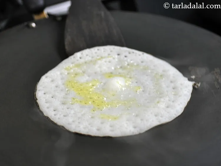 Step 31 – Once you see the dosa is cooked and turned light brown, open the lid.